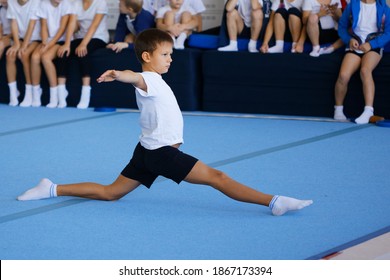 boy performing gymnastic exercises in the gym