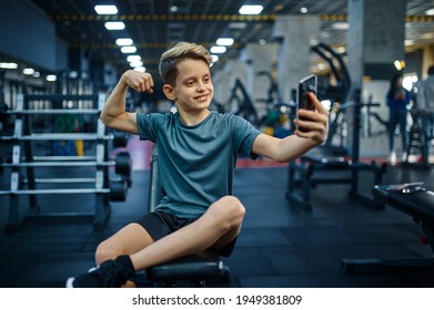 Boy With Phone Makes Selfie On Bench In Gym