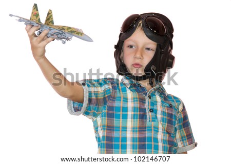 Boy in pilot helmet play with jet fighter model