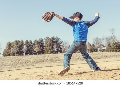 Boy Pitching A Baseball In The Early Spring