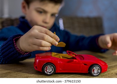 Boy Placing Seat In A Model Car Kit