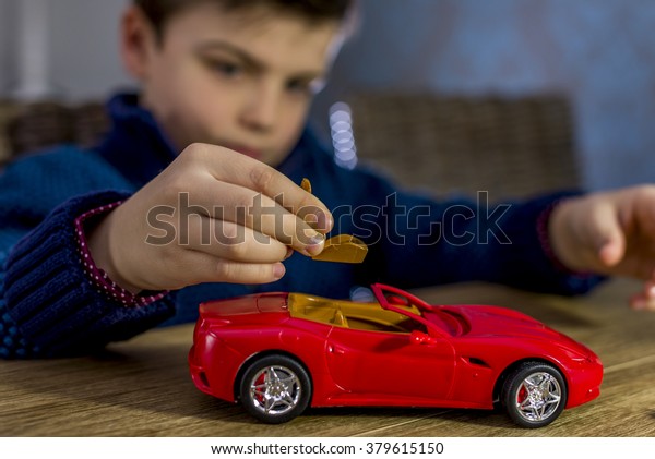 boy placing seat in a\
model car kit