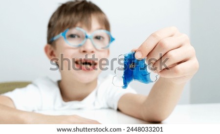 Boy with a plate for teeth alignment