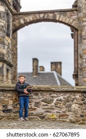 Boy Playing Bagpipe In Edinburgh Castle In Spring