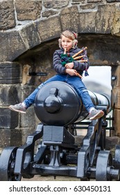 Boy Playing Bagpipe In Edinburgh Castle In Spring