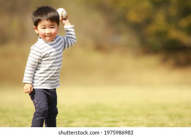 Boy playing with a baseball ball  - Powered by Shutterstock