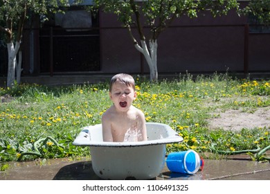 boy is playing in the bathroom outdoors