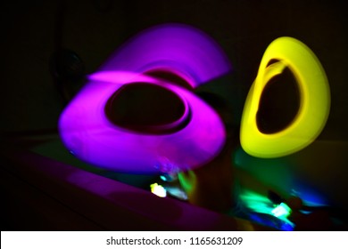 Boy Playing In The Bathtub Making A Light Painting With Glow Sticks