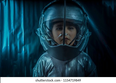 Boy Playing To Be An Astronaut With Space Helmet And Metal Suit