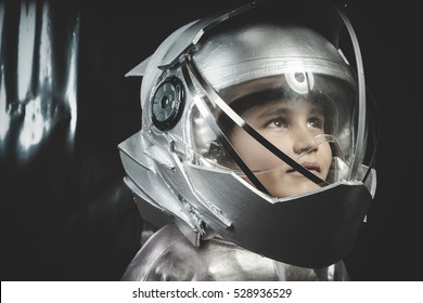 Boy Playing To Be An Astronaut With Space Helmet And Metal Suit