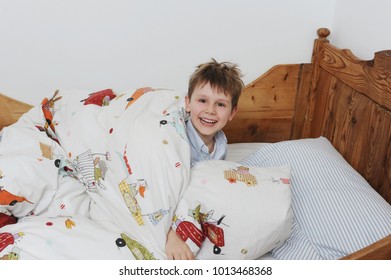 Boy playing in bed