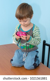 The boy is playing with the camera