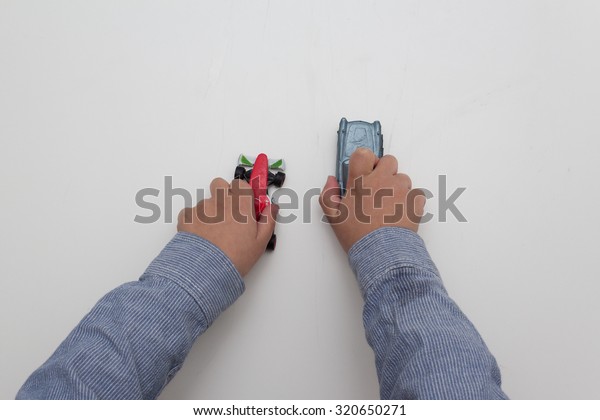 boy playing with cars - hands isolated on
white background