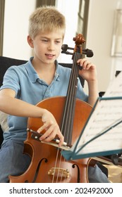 Boy Playing Cello At Home