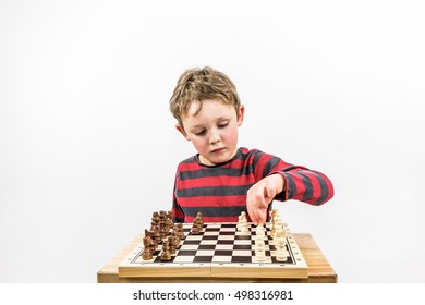 Boy playing chess with himself, portrait studio shot. Landscape format. 