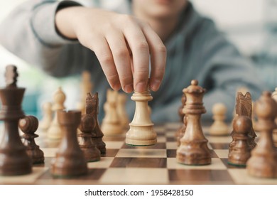 Boy Playing Chess And Moving A Piece, Hand Close Up