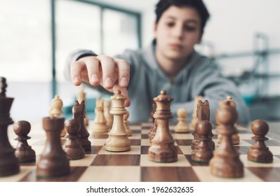 Boy Playing Chess And Moving A Piece, Hand Close Up