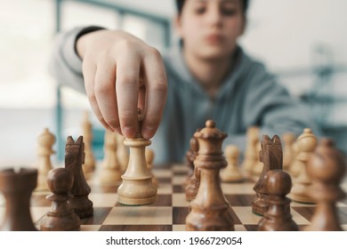 Boy Playing Chess And Moving A Piece, Hand Close Up