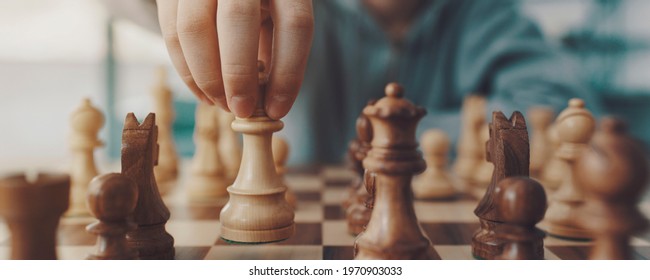 Boy Playing Chess And Moving A Piece, Hand Close Up