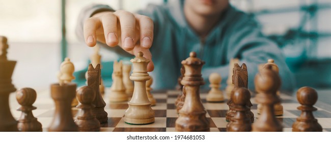 Boy Playing Chess And Moving A Piece, Hand Close Up