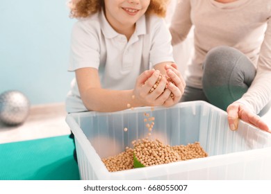 Boy Playing With Chickpeas During His Sensory Integration Therapy