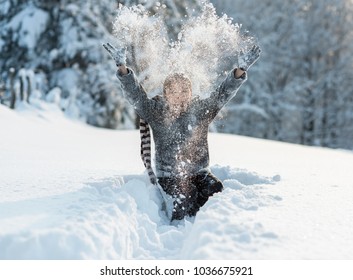 boy is playing in deep snow