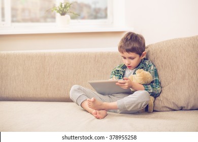 boy playing with digital tablet