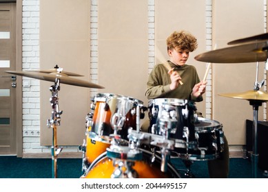 Boy playing drum kit. Lesson at the music school.