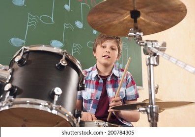 Boy Playing Drums At Music Class