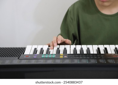 
Boy playing electric keyboard. Preteen in music classes. Music lessons with background with copy space. Student in classes. - Powered by Shutterstock