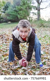 Boy Playing Football In His Backyard