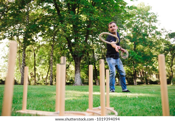 Boy Playing Game Throwing Rings Outdoors Stock Photo 1019394094