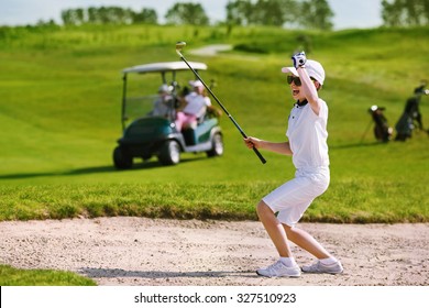 Boy playing golf and enjoing on the successful hit