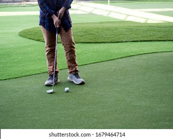 A Boy Playing Golf On Artificial Turf For Swing Practice. Golfing Must Be Diligent And Trained To Know How To Use The Weight To Hit In The Right Direction. Golf Helps Children To Concentrate More.