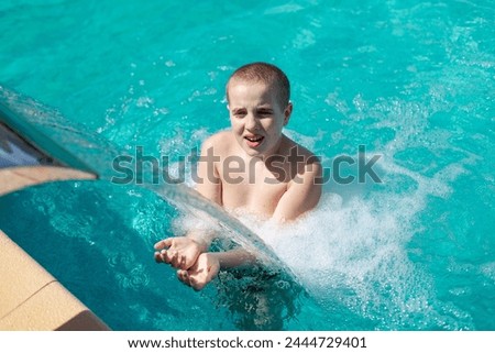 Boy playing in the hotel pool