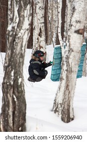 Boy Playing Laser Tag In The Woods