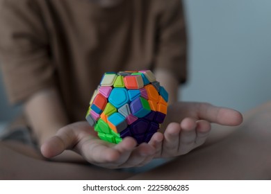 boy playing with megaminx, closeup - Shutterstock ID 2225806285