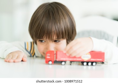 Boy Playing With No Name Truck Toy