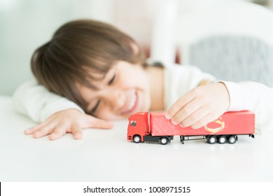 Boy Playing With No Name Truck Toy