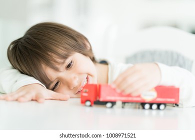 Boy Playing With No Name Truck Toy