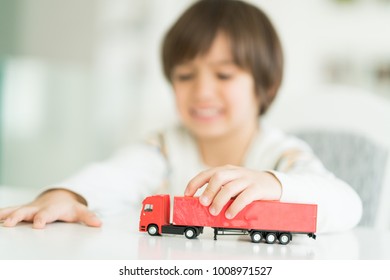 Boy Playing With No Name Truck Toy