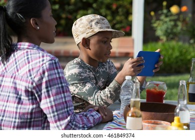 Boy Playing On Digital Game At Homecoming Party