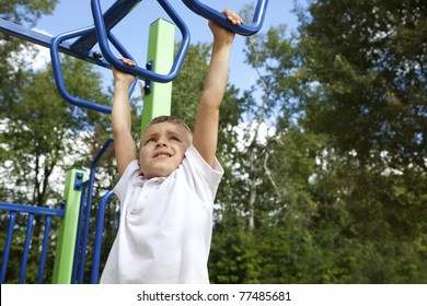 Boy Playing On Monkey Bars