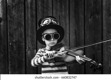 Boy Playing On A Red Violin