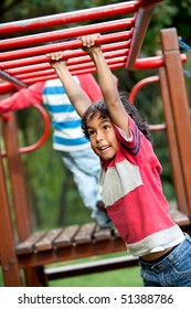 Boy Playing At The Park On The Monkey Bars