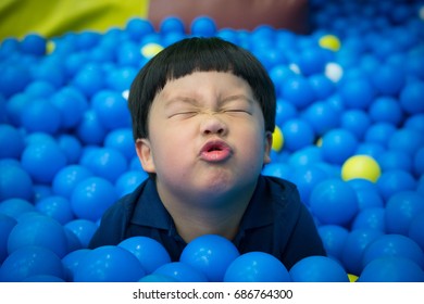 A Boy Is Playing In The Plastic Ball Land.