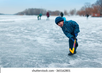 Boy Playing Pond Hockey