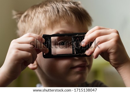 Similar – Child with reading magnifier