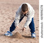 boy playing in the sand