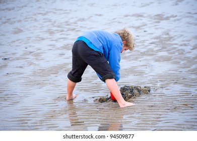 boy is playing in the sand